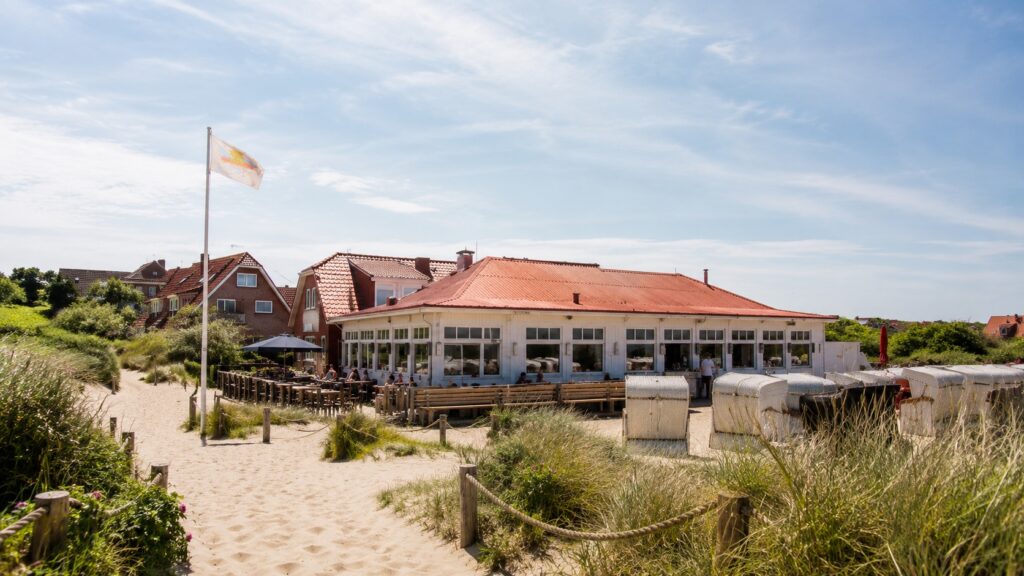 Strandcafé Baltrum, weißes Strandrestaurant mit Strandkörben in den Dünen